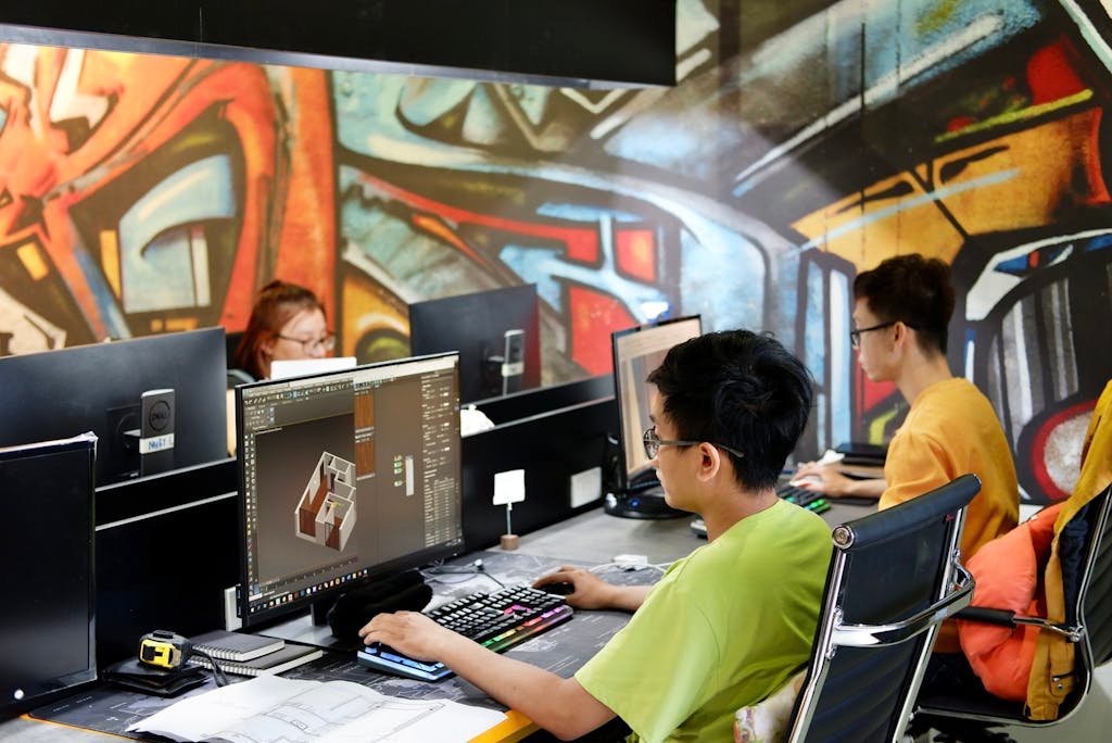 Young People Sitting and Working on Computers